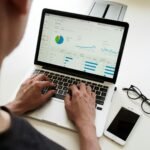 Team reviewing marketing charts on a laptop